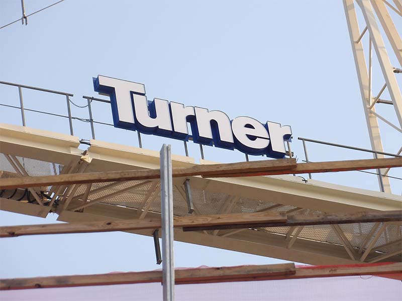 Custom tower crane letters mounted on crane