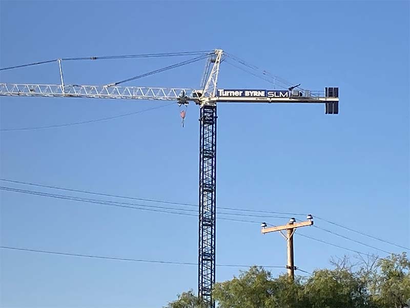Tower crane sign installed high above construction site