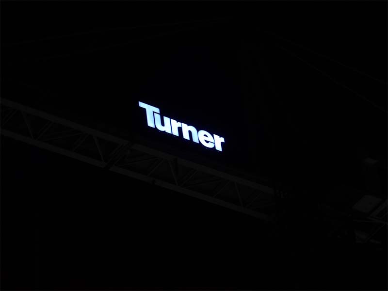Illuminated tower crane sign at night