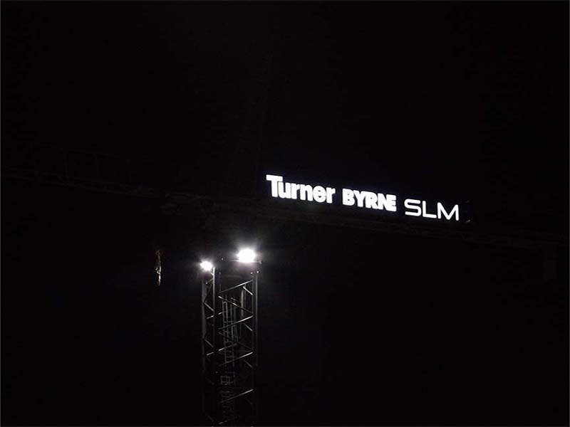 Tower crane company signage visible at night